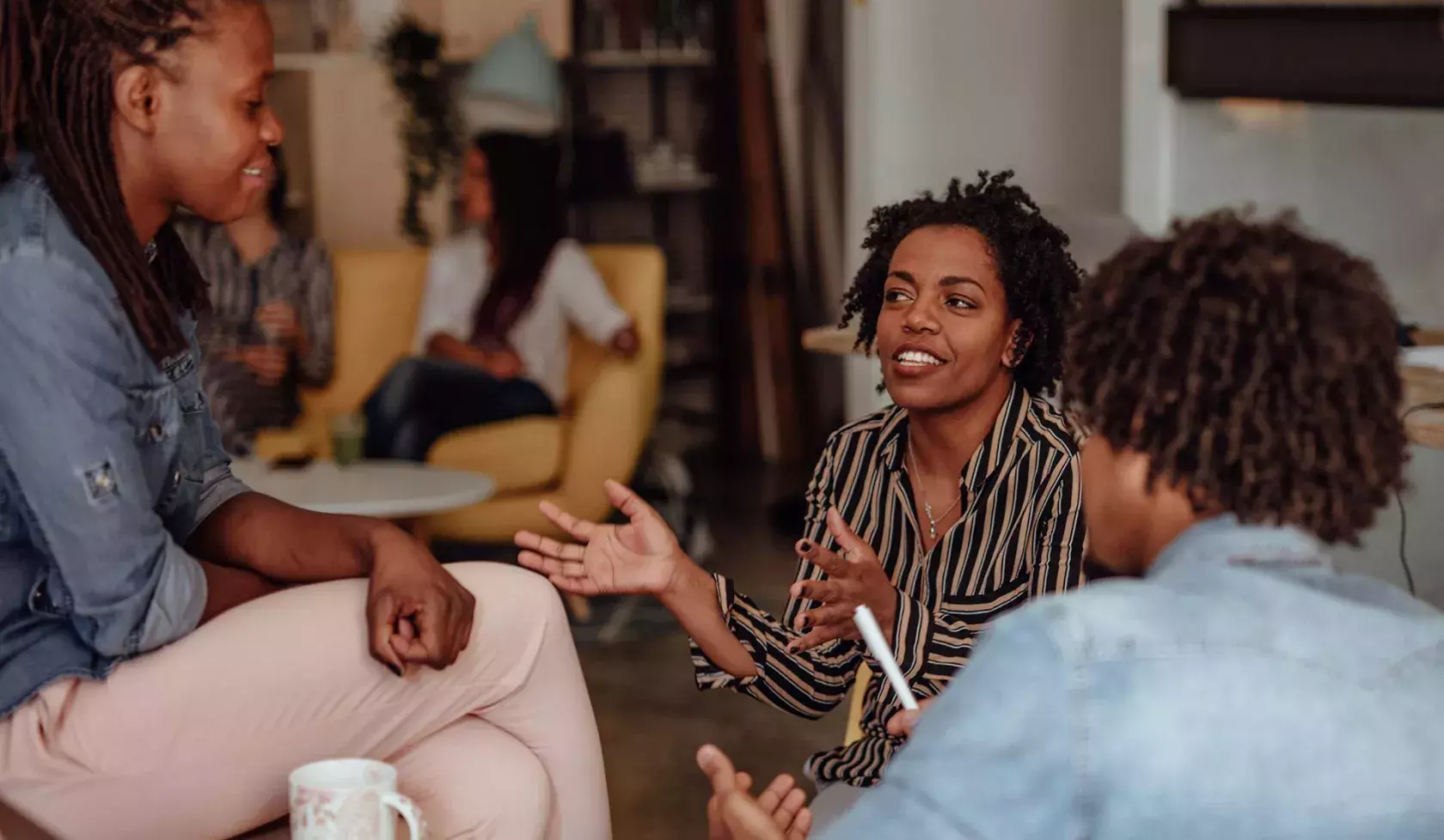 Young Black Female in Casual Group - Speaking
