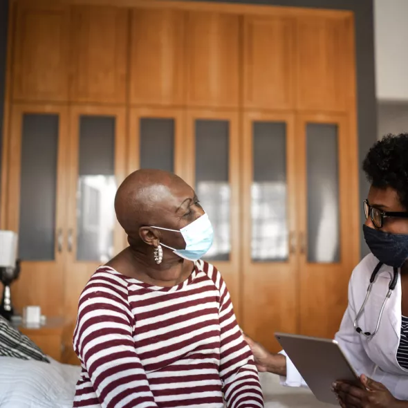 Older Masked Woman at Doctor's Visit