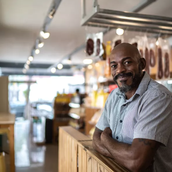Black Business Owner Smiling at Camera - Inside