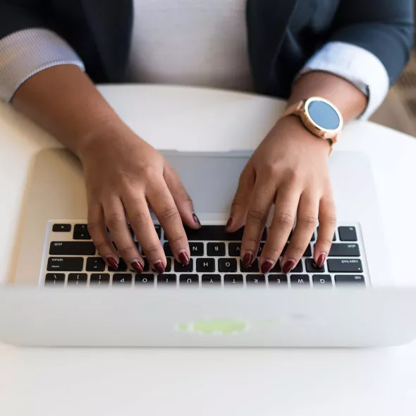 Close-up - Female Black Hands Typing on Laptop Keyboard