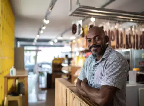 Black Business Owner Smiling at Camera - Inside