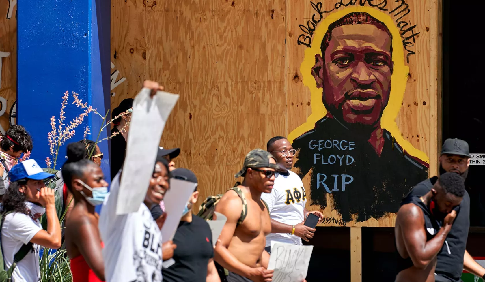 Group in march or protest - George Floyd Sign in Background