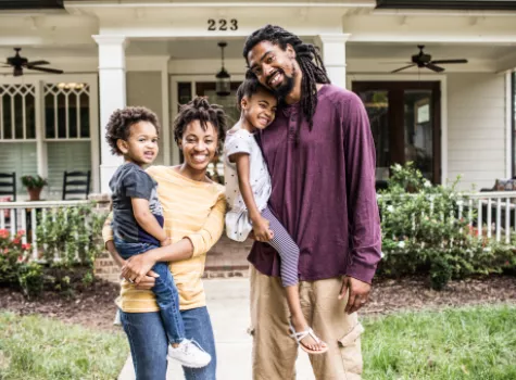 Happy Black Family in front of house