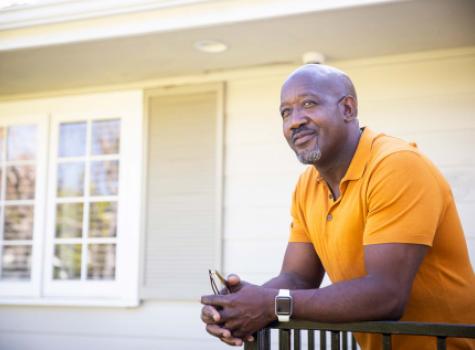 Black Male in Front of House Smiling