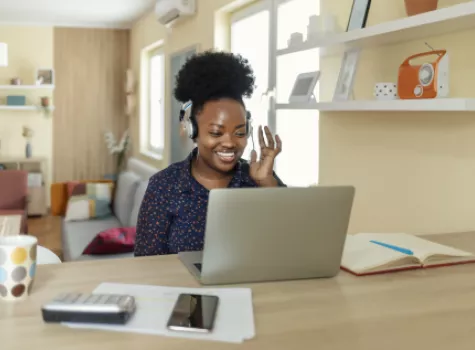 Black Woman Wearing Headphones with Laptop - Indoors