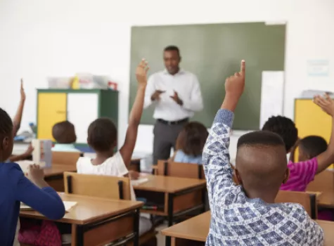 Students Raising Hands in Classroom